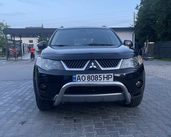 Черный Мицубиси Аутлендер, объемом двигателя 2.4 л и пробегом 290 тыс. км за 9500 $, фото 1 на Automoto.ua