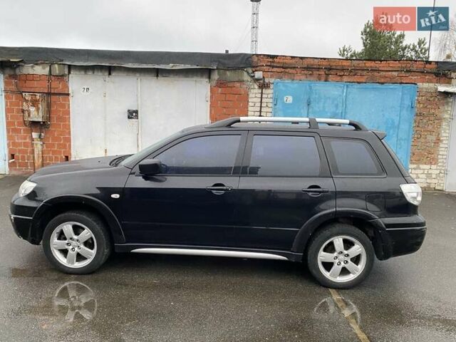 Черный Мицубиси Аутлендер, объемом двигателя 2 л и пробегом 306 тыс. км за 6500 $, фото 1 на Automoto.ua