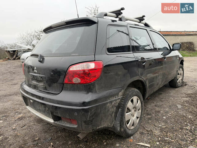 Черный Мицубиси Аутлендер, объемом двигателя 2 л и пробегом 200 тыс. км за 2999 $, фото 1 на Automoto.ua