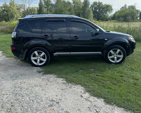 Черный Мицубиси Аутлендер, объемом двигателя 2.36 л и пробегом 240 тыс. км за 9599 $, фото 2 на Automoto.ua