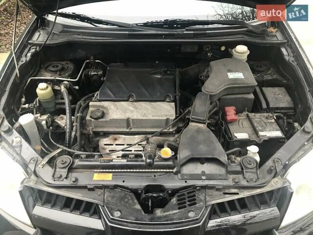 Чорний Міцубісі Аутлендер, об'ємом двигуна 2.38 л та пробігом 207 тис. км за 7000 $, фото 38 на Automoto.ua