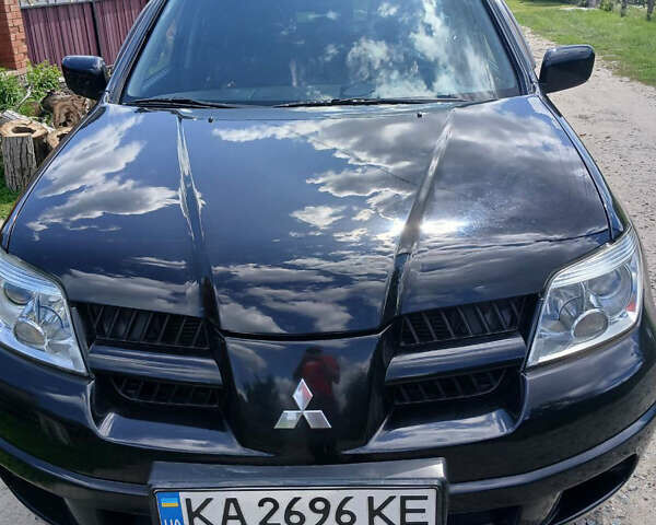 Чорний Міцубісі Аутлендер, об'ємом двигуна 2 л та пробігом 161 тис. км за 7499 $, фото 1 на Automoto.ua