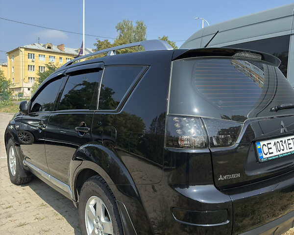 Черный Мицубиси Аутлендер, объемом двигателя 2.36 л и пробегом 255 тыс. км за 9500 $, фото 5 на Automoto.ua