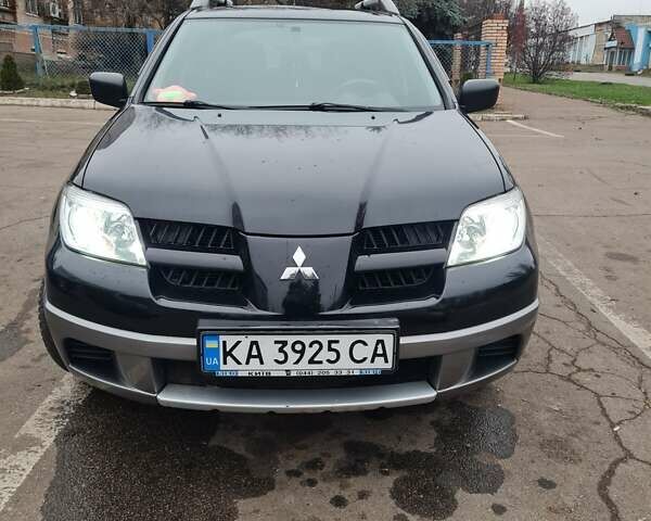 Черный Мицубиси Аутлендер, объемом двигателя 2 л и пробегом 212 тыс. км за 7900 $, фото 1 на Automoto.ua
