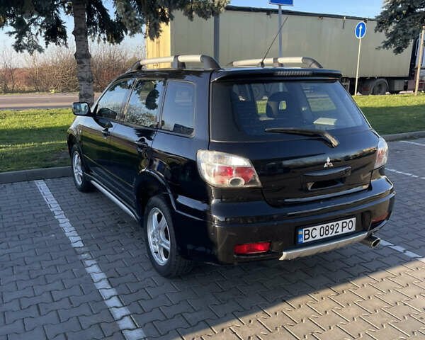 Чорний Міцубісі Аутлендер, об'ємом двигуна 2 л та пробігом 218 тис. км за 6300 $, фото 5 на Automoto.ua