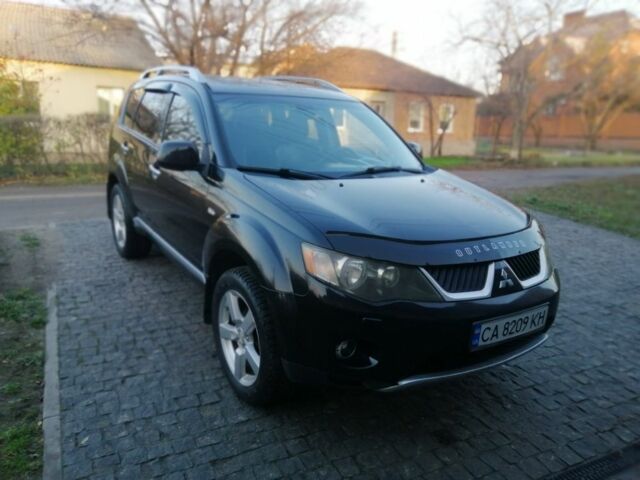 Черный Мицубиси Аутлендер, объемом двигателя 2.4 л и пробегом 228 тыс. км за 7850 $, фото 1 на Automoto.ua