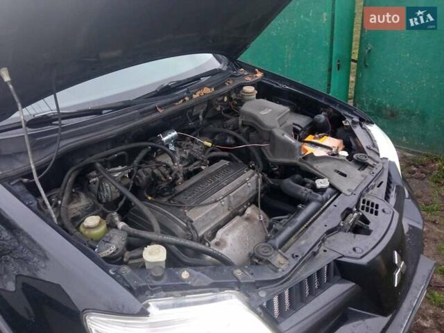 Чорний Міцубісі Аутлендер, об'ємом двигуна 2 л та пробігом 220 тис. км за 5599 $, фото 4 на Automoto.ua