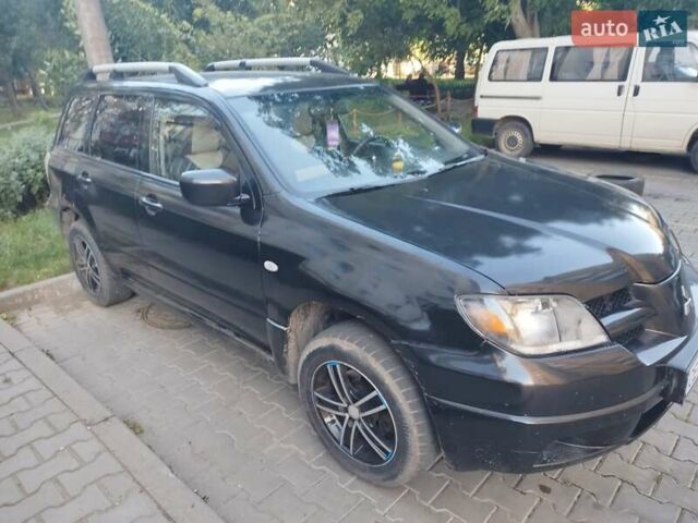 Черный Мицубиси Аутлендер, объемом двигателя 2 л и пробегом 245 тыс. км за 5500 $, фото 2 на Automoto.ua