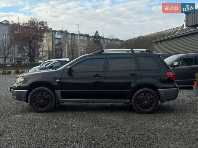 Черный Мицубиси Аутлендер, объемом двигателя 2 л и пробегом 240 тыс. км за 5500 $, фото 2 на Automoto.ua
