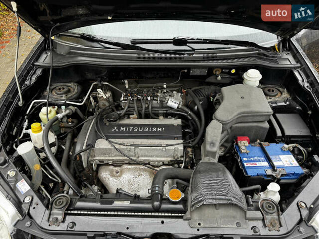 Чорний Міцубісі Аутлендер, об'ємом двигуна 2 л та пробігом 254 тис. км за 7499 $, фото 20 на Automoto.ua