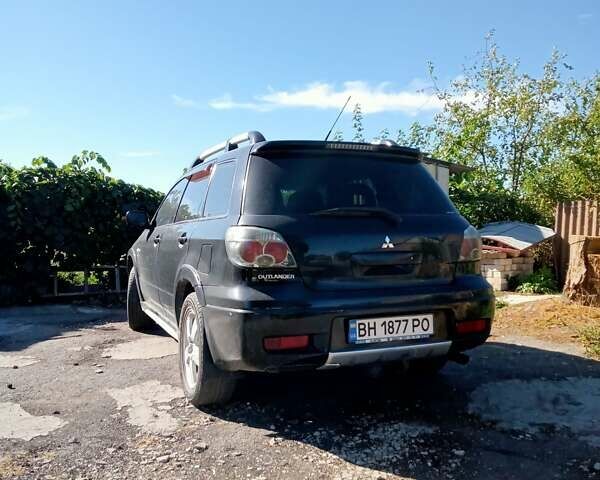 Черный Мицубиси Аутлендер, объемом двигателя 2 л и пробегом 240 тыс. км за 6500 $, фото 2 на Automoto.ua