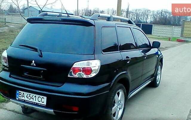 Черный Мицубиси Аутлендер, объемом двигателя 2.4 л и пробегом 150 тыс. км за 6300 $, фото 1 на Automoto.ua