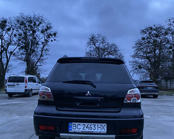 Чорний Міцубісі Аутлендер, об'ємом двигуна 2 л та пробігом 271 тис. км за 6799 $, фото 4 на Automoto.ua