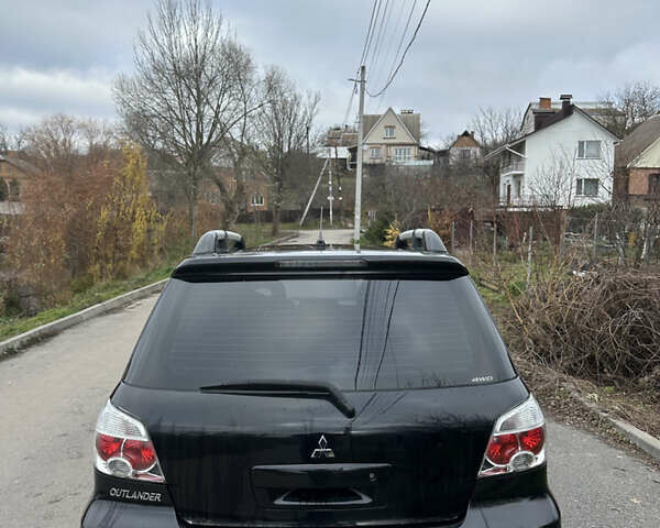 Чорний Міцубісі Аутлендер, об'ємом двигуна 2 л та пробігом 118 тис. км за 8100 $, фото 12 на Automoto.ua