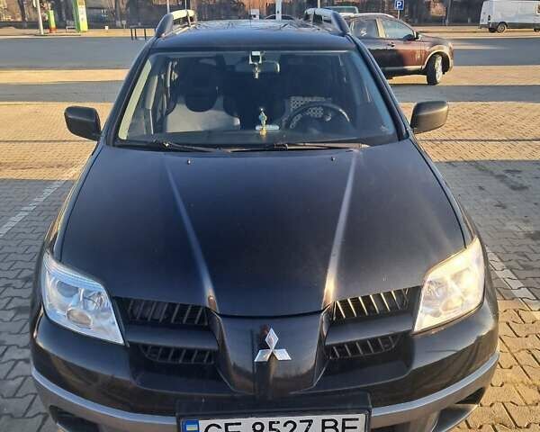 Черный Мицубиси Аутлендер, объемом двигателя 2 л и пробегом 190 тыс. км за 8000 $, фото 1 на Automoto.ua