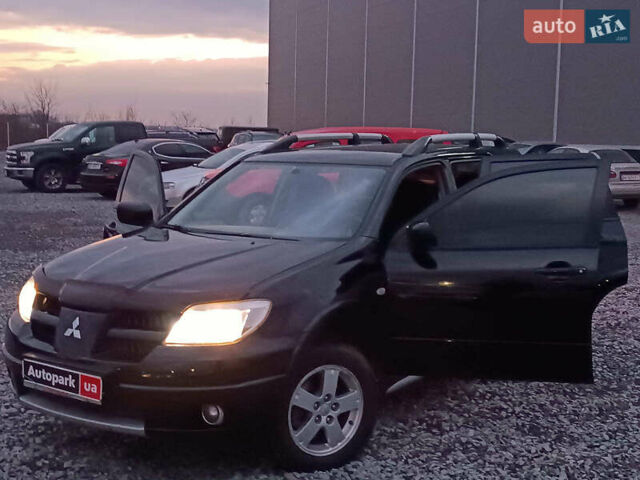 Чорний Міцубісі Аутлендер, об'ємом двигуна 2 л та пробігом 271 тис. км за 6940 $, фото 23 на Automoto.ua