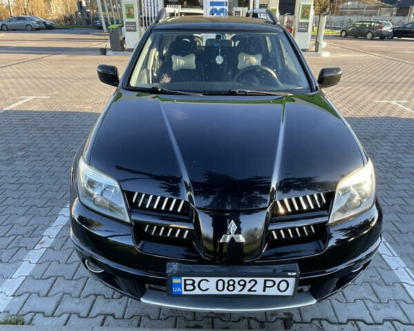 Чорний Міцубісі Аутлендер, об'ємом двигуна 2 л та пробігом 218 тис. км за 6300 $, фото 3 на Automoto.ua