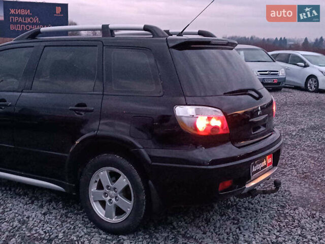 Чорний Міцубісі Аутлендер, об'ємом двигуна 2 л та пробігом 271 тис. км за 6940 $, фото 4 на Automoto.ua