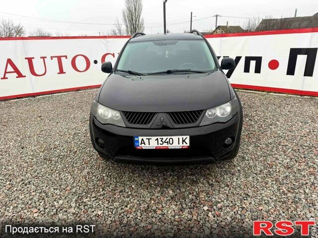 Черный Мицубиси Аутлендер, объемом двигателя 2.4 л и пробегом 200 тыс. км за 9999 $, фото 1 на Automoto.ua