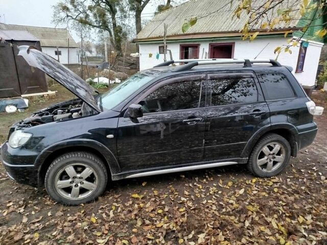 Черный Мицубиси Аутлендер, объемом двигателя 2.4 л и пробегом 149 тыс. км за 8800 $, фото 1 на Automoto.ua