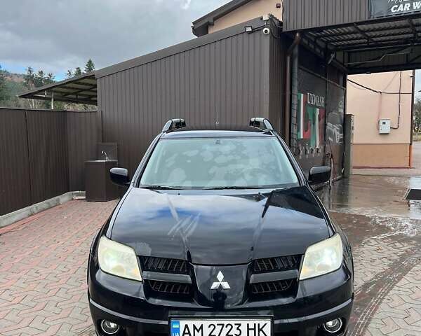 Черный Мицубиси Аутлендер, объемом двигателя 2.38 л и пробегом 220 тыс. км за 7500 $, фото 1 на Automoto.ua