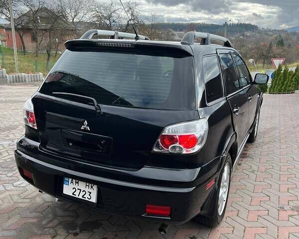 Черный Мицубиси Аутлендер, объемом двигателя 2.38 л и пробегом 220 тыс. км за 7500 $, фото 4 на Automoto.ua