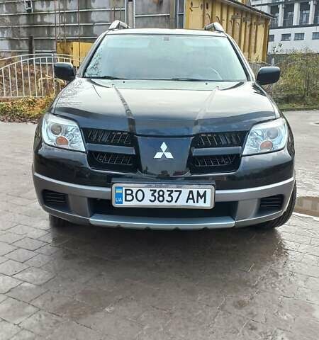 Черный Мицубиси Аутлендер, объемом двигателя 2 л и пробегом 73 тыс. км за 9500 $, фото 1 на Automoto.ua