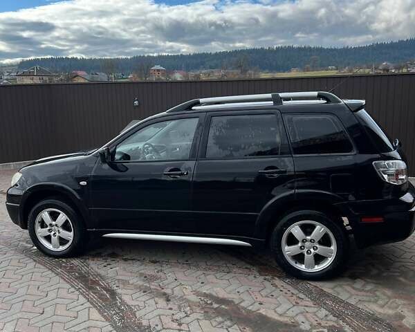 Черный Мицубиси Аутлендер, объемом двигателя 2.38 л и пробегом 220 тыс. км за 7500 $, фото 6 на Automoto.ua