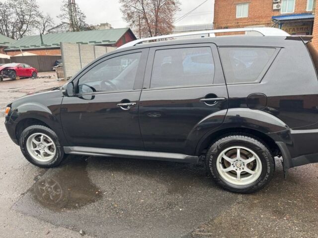 Черный Мицубиси Аутлендер, объемом двигателя 2.4 л и пробегом 305 тыс. км за 10000 $, фото 1 на Automoto.ua