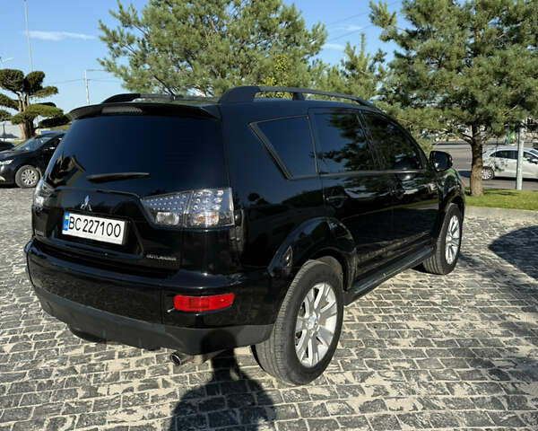 Черный Мицубиси Аутлендер, объемом двигателя 2.4 л и пробегом 252 тыс. км за 11200 $, фото 1 на Automoto.ua