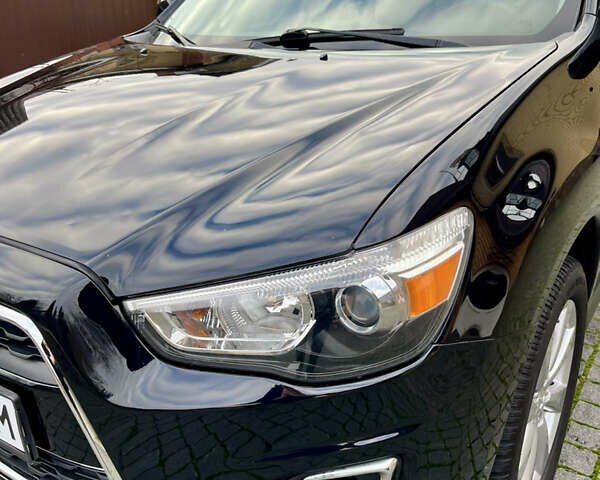 Чорний Міцубісі Аутлендер, об'ємом двигуна 2 л та пробігом 170 тис. км за 10999 $, фото 15 на Automoto.ua