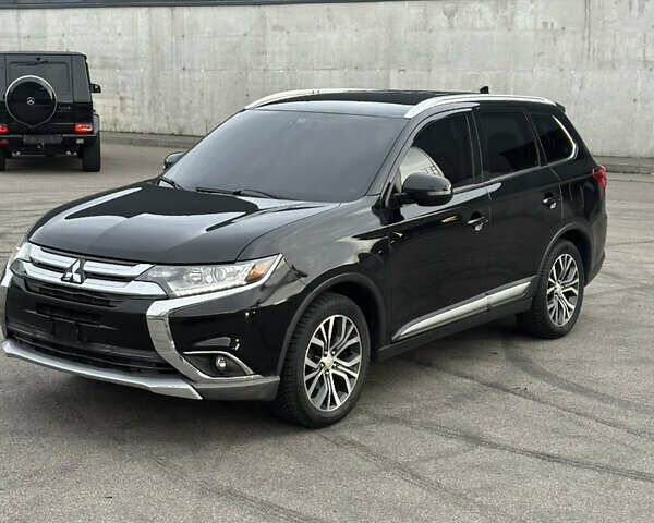 Черный Мицубиси Аутлендер, объемом двигателя 2.36 л и пробегом 128 тыс. км за 15500 $, фото 1 на Automoto.ua