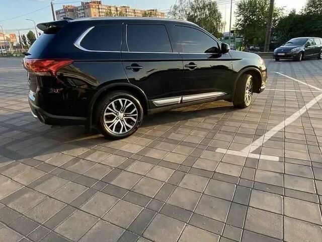 Черный Мицубиси Аутлендер, объемом двигателя 2.4 л и пробегом 75 тыс. км за 13000 $, фото 1 на Automoto.ua