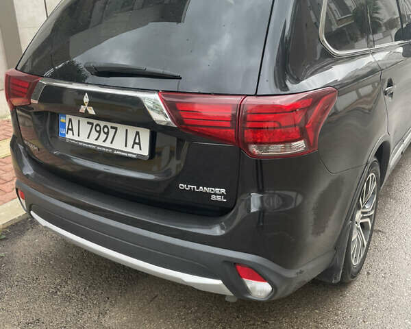 Чорний Міцубісі Аутлендер, об'ємом двигуна 2.4 л та пробігом 180 тис. км за 15500 $, фото 1 на Automoto.ua