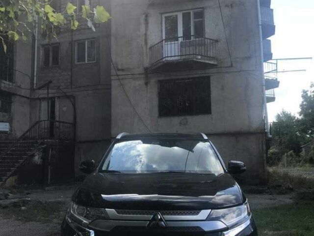Черный Мицубиси Аутлендер, объемом двигателя 2.4 л и пробегом 125 тыс. км за 11200 $, фото 1 на Automoto.ua