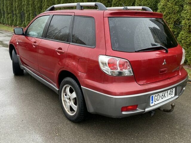 Красный Мицубиси Аутлендер, объемом двигателя 2.4 л и пробегом 293 тыс. км за 3595 $, фото 1 на Automoto.ua