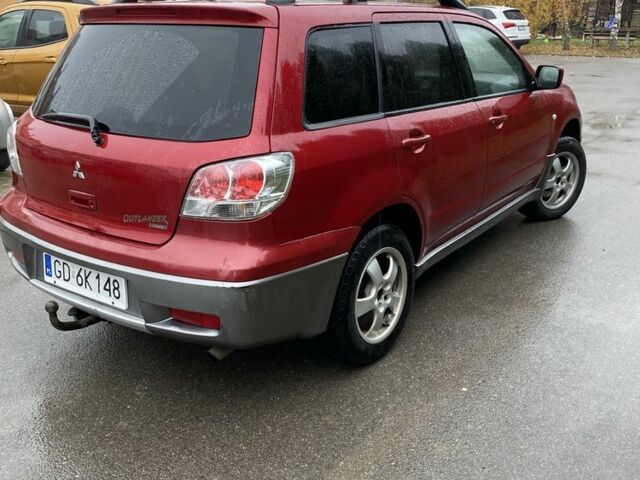 Красный Мицубиси Аутлендер, объемом двигателя 2.4 л и пробегом 293 тыс. км за 3595 $, фото 2 на Automoto.ua