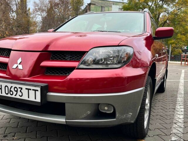 Красный Мицубиси Аутлендер, объемом двигателя 2.4 л и пробегом 174 тыс. км за 6900 $, фото 3 на Automoto.ua