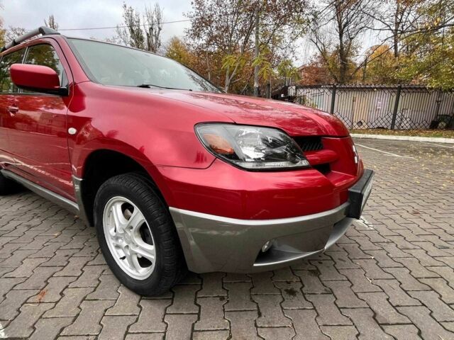 Красный Мицубиси Аутлендер, объемом двигателя 2.4 л и пробегом 174 тыс. км за 6900 $, фото 1 на Automoto.ua