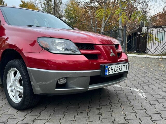 Красный Мицубиси Аутлендер, объемом двигателя 2.4 л и пробегом 174 тыс. км за 6900 $, фото 2 на Automoto.ua
