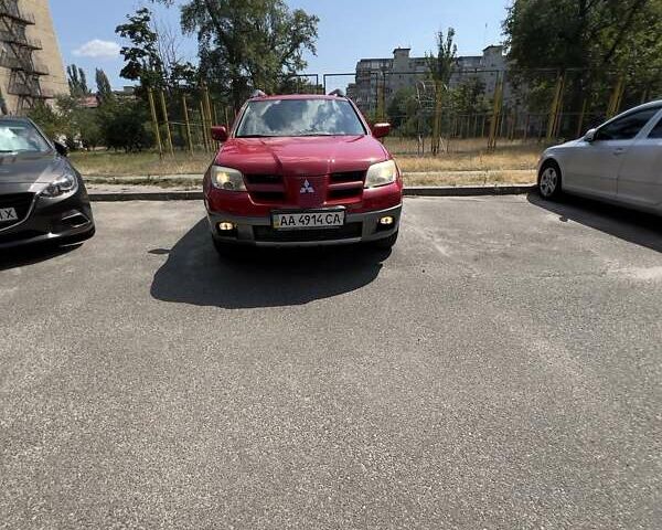 Красный Мицубиси Аутлендер, объемом двигателя 2.4 л и пробегом 193 тыс. км за 7999 $, фото 2 на Automoto.ua