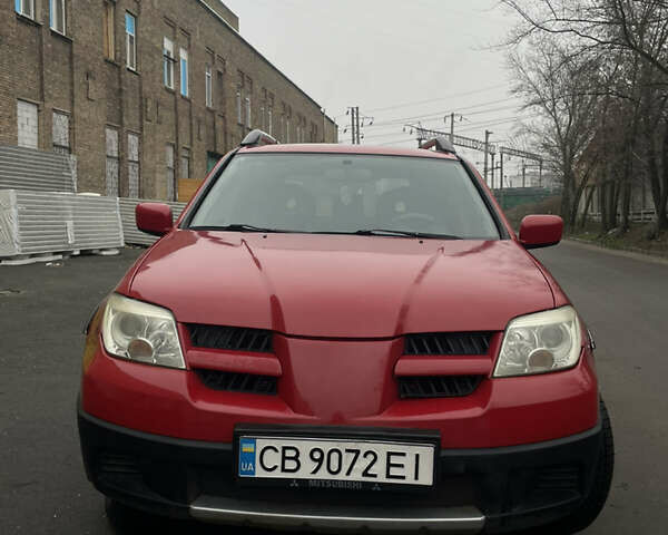 Красный Мицубиси Аутлендер, объемом двигателя 2.4 л и пробегом 224 тыс. км за 5600 $, фото 1 на Automoto.ua