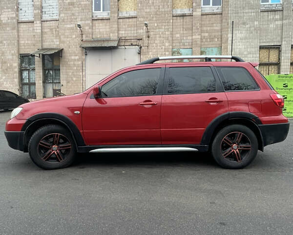 Красный Мицубиси Аутлендер, объемом двигателя 2.4 л и пробегом 224 тыс. км за 5600 $, фото 3 на Automoto.ua