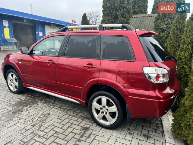 Червоний Міцубісі Аутлендер, об'ємом двигуна 2.4 л та пробігом 187 тис. км за 5600 $, фото 1 на Automoto.ua