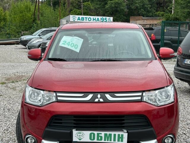 Красный Мицубиси Аутлендер, объемом двигателя 2.4 л и пробегом 213 тыс. км за 11900 $, фото 1 на Automoto.ua