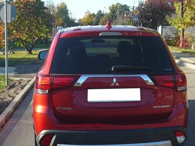 Красный Мицубиси Аутлендер, объемом двигателя 2.4 л и пробегом 117 тыс. км за 10500 $, фото 2 на Automoto.ua