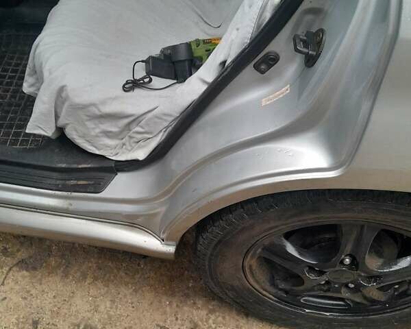 Серый Мицубиси Аутлендер, объемом двигателя 2.4 л и пробегом 250 тыс. км за 5600 $, фото 4 на Automoto.ua