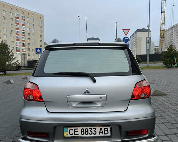 Серый Мицубиси Аутлендер, объемом двигателя 2.38 л и пробегом 180 тыс. км за 6000 $, фото 4 на Automoto.ua