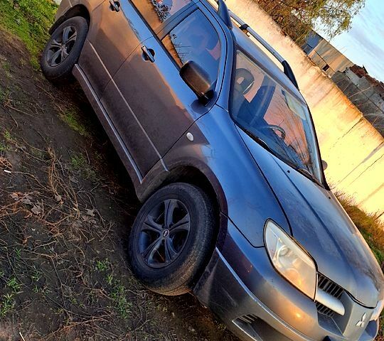 Сірий Міцубісі Аутлендер, об'ємом двигуна 2.4 л та пробігом 211 тис. км за 5000 $, фото 1 на Automoto.ua