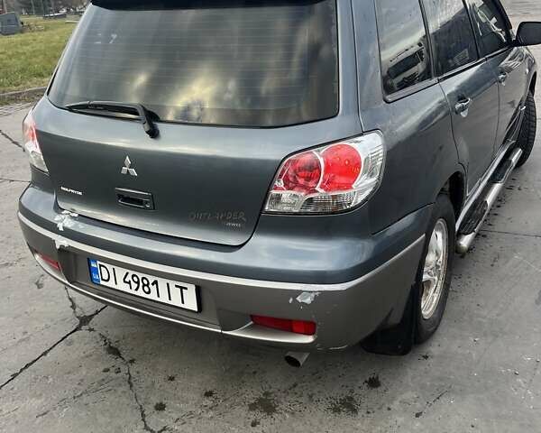 Синий Мицубиси Аутлендер, объемом двигателя 2.38 л и пробегом 300 тыс. км за 4200 $, фото 2 на Automoto.ua